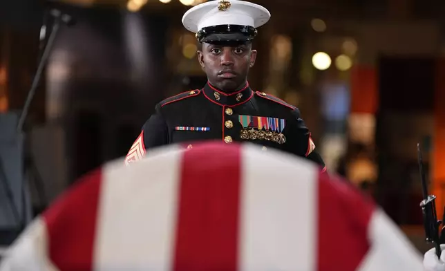 Marine Staff Sgt. Nayya Dobson-EL stands as part of the Guard of Honor at the flag-draped casket of former President Jimmy Carter as he lies in repose at the Jimmy Carter Presidential Library and Museum in Atlanta, Saturday, Jan. 4, 2025. Carter died Dec. 29 at the age of 100. (AP Photo/Alex Brandon, Pool)