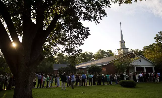 FILE - People wait in line outside Maranatha Baptist Church in Plains, Ga., to get into a Sunday school class taught by former U.S. President Jimmy Carter on Aug. 23, 2015. It was Carter's first lesson since announcing plans for intravenous drug doses and radiation to treat melanoma found in his brain after surgery to remove a tumor from his liver. (AP Photo/David Goldman, File)