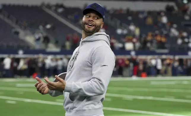 Dallas Cowboys quarterback Dak Prescott stands on the field prior to an NFL football game against the Washington Commanders, Sunday, Jan. 5, 2025, in Arlington, Texas. (AP Photo/Gareth Patterson)