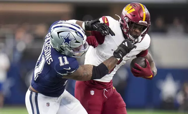 Washington Commanders cornerback Mike Sainristil, right, is pushed out of bounds by Dallas Cowboys linebacker Micah Parsons during the second half of an NFL football game, Sunday, Jan. 5, 2025, in Arlington, Texas. (AP Photo/Josh McSwain)