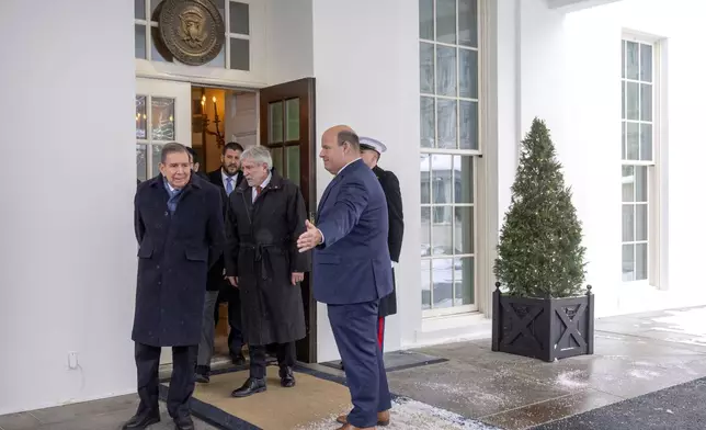 Venezuela's opposition leader Edmundo Gonzalez, left, arrives to speak with reporters at the White House, Monday, Jan. 6, 2025, in Washington. (AP Photo/Mark Schiefelbein)