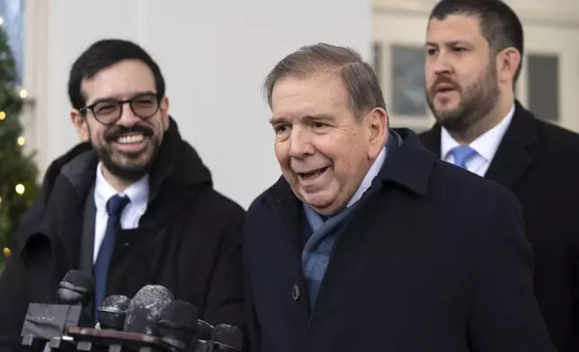 Venezuela's opposition leader Edmundo Gonzalez, center, speaks with reporters at the White House, Monday, Jan. 6, 2025, in Washington. (AP Photo/Mark Schiefelbein)