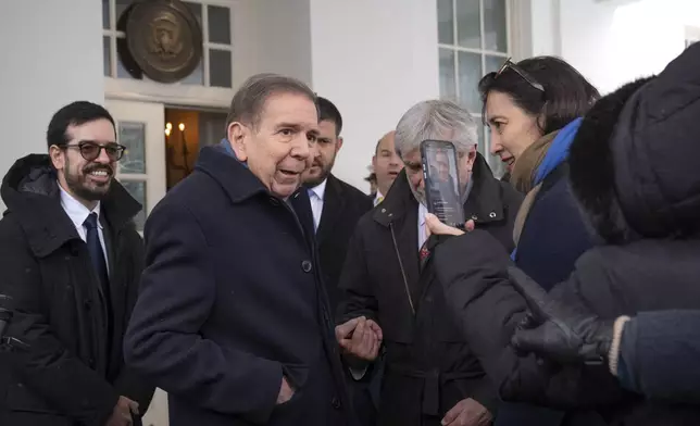 Venezuela's opposition leader Edmundo Gonzalez, center, speaks with reporters at the White House, Monday, Jan. 6, 2025, in Washington. (AP Photo/Mark Schiefelbein)