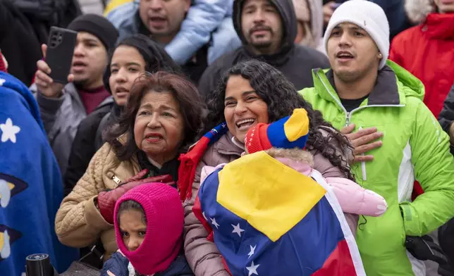 Carolina di Martino Popovich, center, holds her daughter Isabella, 1, next to her mother Petra Gambor, and other daughter Camila, 6, as they sing along with Venezuelan opposition leader Edmundo Gonzalez, outside of the Organization of American States, Monday, Jan. 6, 2025, in Washington. "We drove 10 hours in the snowstorm from Boston and we made it," said di Martino Popovich, "that is how much he means to us. We couldn't vote in Venezuela but we are here to recognize him as our President." The mother and daughter are long time immigrants from Venezuela who live in Boston. (AP Photo/Jacquelyn Martin)