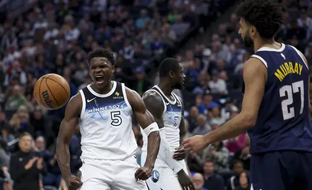 Minnesota Timberwolves guard Anthony Edwards (5) celebrates after scoring while Denver Nuggets guard Jamal Murray (27) reacts during the first half of an NBA basketball game, Saturday, Jan. 25, 2025, in Minneapolis. (AP Photo/Ellen Schmidt)