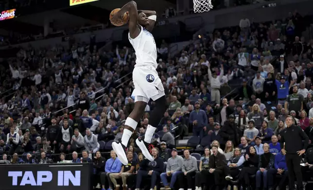 Minnesota Timberwolves guard Anthony Edwards (5) prepares to dunk during the first half of an NBA basketball game against the Denver Nuggets, Saturday, Jan. 25, 2025, in Minneapolis. (AP Photo/Ellen Schmidt)