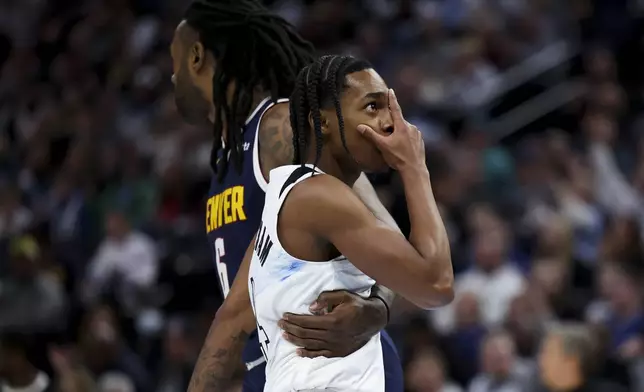 Minnesota Timberwolves guard Rob Dillingham , right, reacts after scoring over Denver Nuggets center DeAndre Jordan (6) during the first half of an NBA basketball game, Saturday, Jan. 25, 2025, in Minneapolis. (AP Photo/Ellen Schmidt)