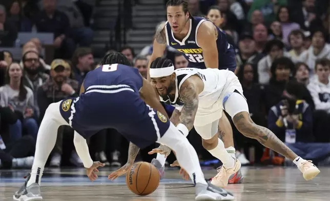 Minnesota Timberwolves guard Nickeil Alexander-Walker (9) dives for a loose ball against Denver Nuggets forward Peyton Watson (8) while Nuggets forward Aaron Gordon (32) looks on during the first half of an NBA basketball game, Saturday, Jan. 25, 2025, in Minneapolis. (AP Photo/Ellen Schmidt)