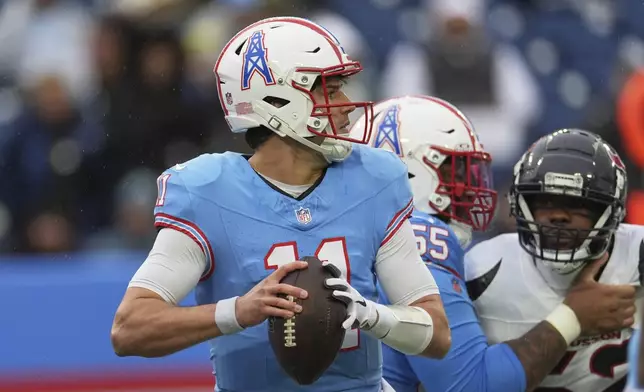 Tennessee Titans quarterback Mason Rudolph (11) drops back to throw a pass against the Houston Texans during the first half of an NFL football game Sunday, Jan. 5, 2025, in Nashville, Tenn. (AP Photo/George Walker IV)