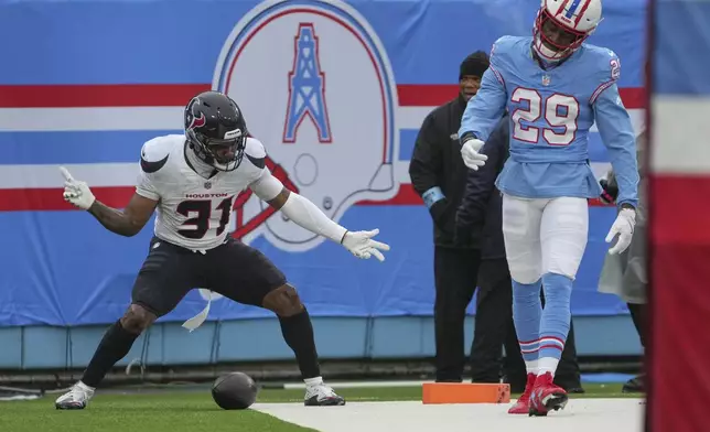 Houston Texans running back Dameon Pierce (31) celebrates after a 92-yard touchdown run as Tennessee Titans cornerback Jarvis Brownlee Jr. (29) looks down during the first half of an NFL football game Sunday, Jan. 5, 2025, in Nashville, Tenn. (AP Photo/George Walker IV)