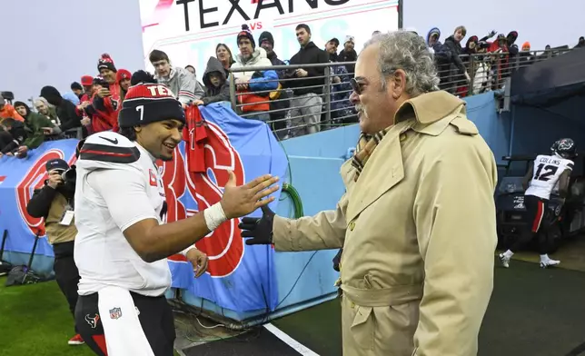 Houston Texans quarterback C.J. Stroud, left, celebrates with owner Cal McNair after an NFL football game against the Tennessee Titans Sunday, Jan. 5, 2025, in Nashville, Tenn. The Texans won 23-14. (AP Photo/John Amis)