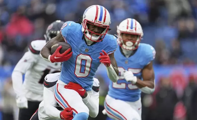 Tennessee Titans wide receiver Calvin Ridley (0) is tackled by Houston Texans safety Calen Bullock after catching a pass during the first half of an NFL football game Sunday, Jan. 5, 2025, in Nashville, Tenn. (AP Photo/George Walker IV)