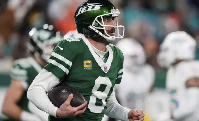 New York Jets quarterback Aaron Rodgers (8) reacts following his 500th career regular-season touchdown pass during the first half of an NFL football game against the Miami Dolphins, Sunday, Jan. 5, 2025, in East Rutherford, N.J. (AP Photo/Seth Wenig)