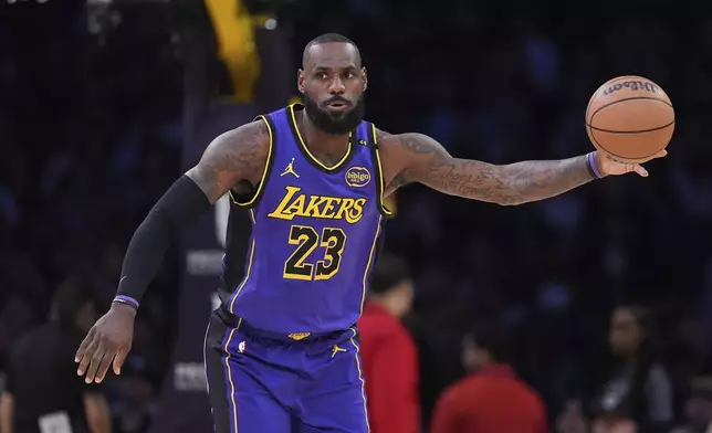 Los Angeles Lakers forward LeBron James takes a pass during the first half of an NBA basketball game against the Atlanta Hawks, Friday, Jan. 3, 2025, in Los Angeles. (AP Photo/Mark J. Terrill)