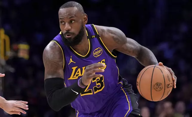 Los Angeles Lakers forward LeBron James drives toward the basket during the first half of an NBA basketball game against the Atlanta Hawks, Friday, Jan. 3, 2025, in Los Angeles. (AP Photo/Mark J. Terrill)