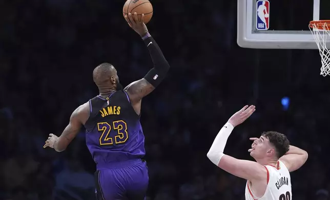 Los Angeles Lakers forward LeBron James, left, shoots as Portland Trail Blazers center Donovan Clingan defends during the second half of an NBA basketball game, Thursday, Jan. 2, 2025, in Los Angeles. (AP Photo/Mark J. Terrill)