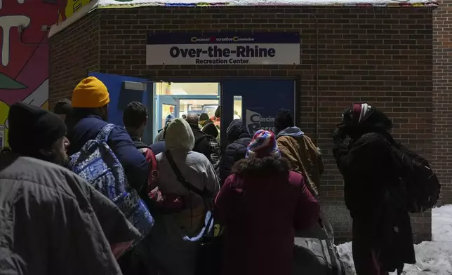 Patrons enter a daytime warming shelter as it opens for the day, Tuesday, Jan. 7, 2025, in Cincinnati. (AP Photo/Joshua A. Bickel)