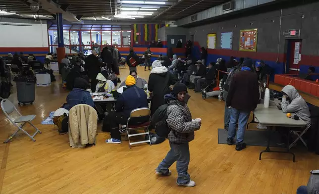 Patrons sit inside a daytime warming shelter, Tuesday, Jan. 7, 2025, in Cincinnati. (AP Photo/Joshua A. Bickel)