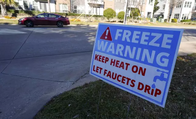 A freeze warning sign is stands outside of an apartment complex ahead of a winter storm expected to hit the North Texas region, Tuesday, Jan. 7, 2025, in Dallas. (AP Photo/Julio Cortez)