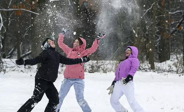 Rosie Henson, from left, Charlotte Hall and Jaya Demni play around in the snow near Schifferstadt Museum in Frederick, Md.,on Monday, Jan. 6. 2025. (Ric Dugan/The Frederick News-Post via AP)