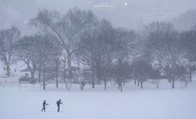 People ski during a winter snow storm in Washington, Monday, Jan. 6, 2025. (AP Photo/Matt Rourke)