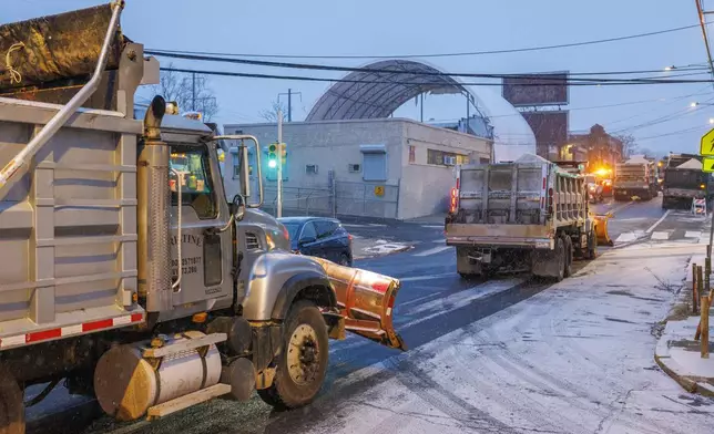 Plow trucks take to the streets after loading with salt in Philadelphia, Monday, Jan. 6, 2025. (Alejandro A. Alvarez/The Philadelphia Inquirer via AP)