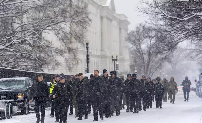 Police from nearby Arlington, Va., arrive at the Capitol to help reinforce the security presence ahead of a joint session of Congress to certify the votes from the Electoral College in the presidential election, in Washington, Monday, Jan. 6, 2025. (AP Photo/J. Scott Applewhite)