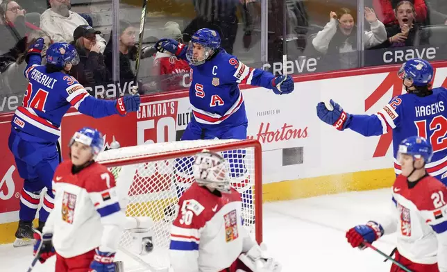 United States forward Ryan Leonard (9) celebrates after his goal with teammates Gabe Perreault (34) and James Hagens (12) during third-period World Junior hockey championship semifinal game action against Czechia in Ottawa, Ontario, Saturday, Jan. 4, 2025. (Sean Kilpatrick/The Canadian Press via AP)