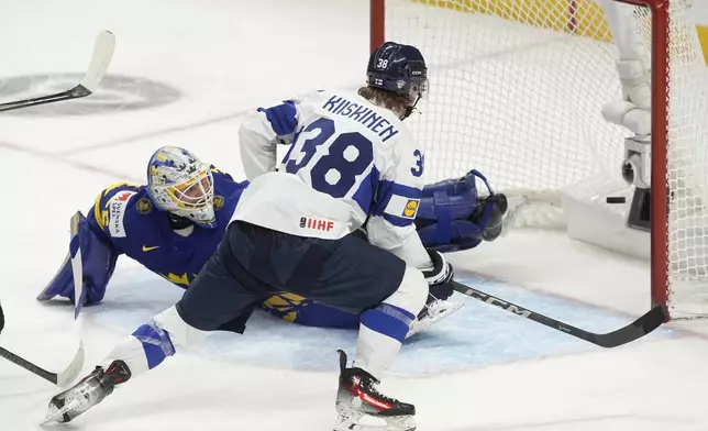 Finland forward Jesse Kiiskinen (38) scores on Sweden goaltender Melker Thelin (35) during the second period of a semifinal game at the world junior hockey championship, Saturday, Jan. 4, 2025 in Ottawa, Ontario. (Adrian Wyld/The Canadian Press via AP)