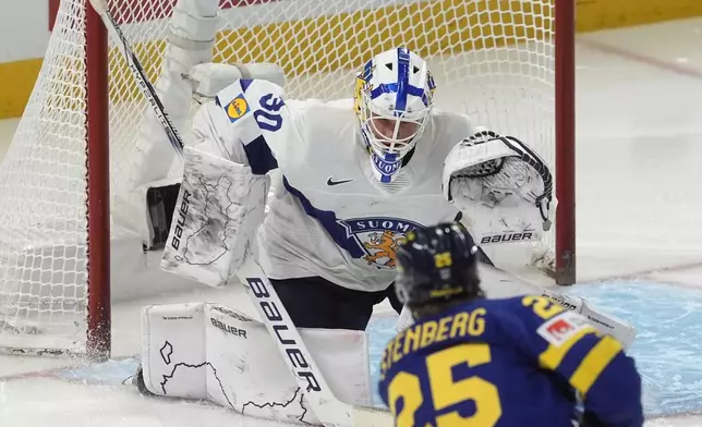 Sweden forward Otto Stenberg (25) scores on Finland goaltender Petteri Rimpinen (30) during second period semifinal IIHF World Junior Hockey Championship tournament action on Saturday, Jan. 4, 2025 in Ottawa. (Adrian Wyld/The Canadian Press via AP)