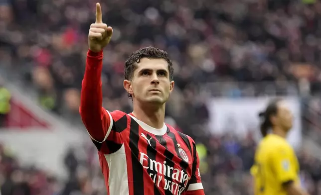 AC Milan's Christian Pulisic celebrates after scoring his side's first goal a Serie A soccer match between AC Milan and Parma, at the San Siro stadium in Milan, Italy, Sunday, Jan. 26, 2025. (AP Photo/Luca Bruno)