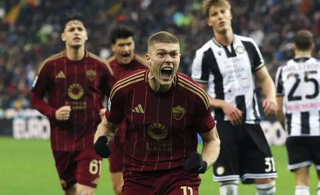 Roma's Artem Dovbyk celebrates scoring their side's second goal of the game during the Serie A soccer match between Udinese and Roma at the Bluenergy Stadium in Udine, Italy, Sunday, Jan. 26, 2025. (Andrea Bressanutti/LaPresse via AP)