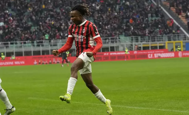 AC Milan's Samuel Chukwueze celebrates after scoring his side's third goal during a Serie A soccer match between AC Milan and Parma, at the San Siro stadium in Milan, Italy, Sunday, Jan. 26, 2025. (AP Photo/Luca Bruno)
