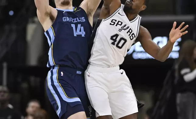 Memphis Grizzlies' Zach Edey (14) and San Antonio Spurs' Harrison Barnes fight for possession during the first half of an NBA basketball game, Friday, Jan. 17, 2025, in San Antonio. (AP Photo/Darren Abate)