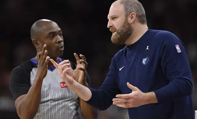 Memphis Grizzlies head coach Taylor Jenkins, right, speaks with referee Courtney Kirkland, left, during the first half of an NBA basketball game against the San Antonio Spurs, Friday, Jan. 17, 2025, in San Antonio. (AP Photo/Darren Abate)