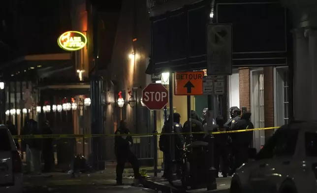 Emergency services attend the scene after a vehicle drove into a crowd on New Orleans' Canal and Bourbon Street, Wednesday Jan. 1, 2025. (AP Photo/Gerald Herbert)