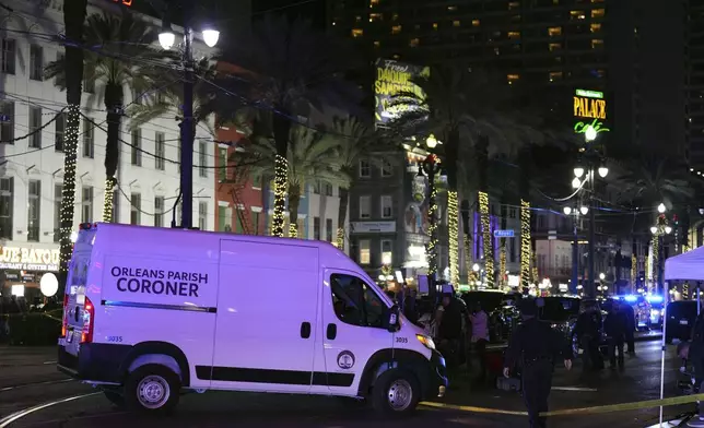 A coroner's van leaves the scene after a vehicle drove into a crowd on New Orleans' Canal and Bourbon streets, Wednesday, Jan. 1, 2025. (AP Photo/George Walker IV)