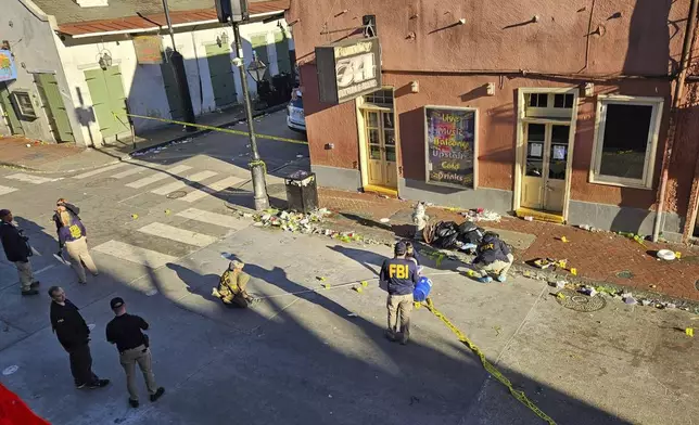 FBI agents work on Bourbon street on Wednesday afternoon, Jan. 1, 2025, near the Four Points by Sheraton hotel in the French Quarter of New Orleans. (Jess Knazs via AP)