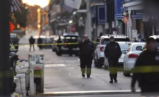 Emergency services attend the scene after a vehicle drove into a crowd on New Orleans' Canal and Bourbon Street, Wednesday Jan. 1, 2025. (AP Photo/Gerald Herbert)