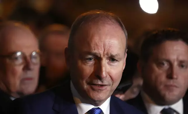 Fianna Fail leader Micheal Martin talks to the media outside the government building in Dublin, Wednesday, Jan. 22, 2025.(AP Photo/Peter Morrison)