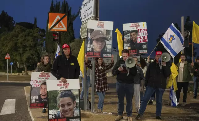 Israeli demonstrators outside the prime minister's office in Jerusalem hold photos of Liri Albag and other hostages during a protest calling for their release from being held in the Gaza Strip by the Hamas militant group, Sunday, Jan. 5, 2025. (AP Photo/Ohad Zwigenberg)