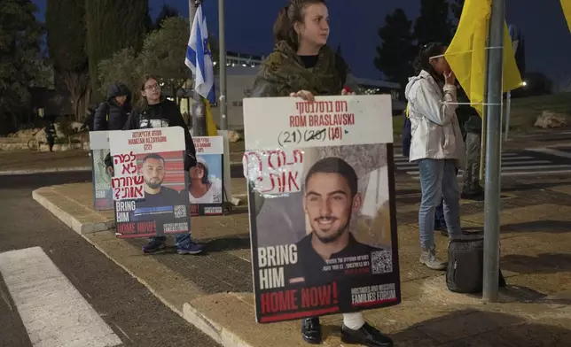 Israeli demonstrators outside the prime minister's office in Jerusalem hold photos of the hostages during a protest calling for the release of hostages held in the Gaza Strip by the Hamas militant group, Sunday, Jan. 5, 2025. (AP Photo/Ohad Zwigenberg)