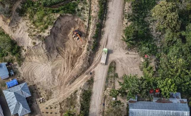 A machine operates near a road leading to the area of wood pellet production companies in Pohuwato, Gorontalo province, Indonesia, Tuesday, Oct. 22, 2024. (AP Photo/Yegar Sahaduta Mangiri)