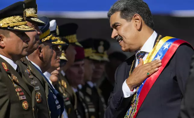 Venezuela's President Nicolas Maduro talks to high-ranking officers during a military ceremony on his inauguration day for a third term in Caracas, Venezuela, Friday, Jan. 10, 2025. (AP Photo/Ariana Cubillos)