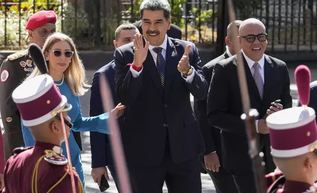 Venezuelan President Nicolas Maduro, center, his wife Cilia Flores, left, and National Assembly President Jorge Rodriguez arrive at the National Assembly for Maduro's swearing-in ceremony for a third term in Caracas, Venezuela, Friday, Jan. 10, 2025.(AP Photo/Matias Delacroix)