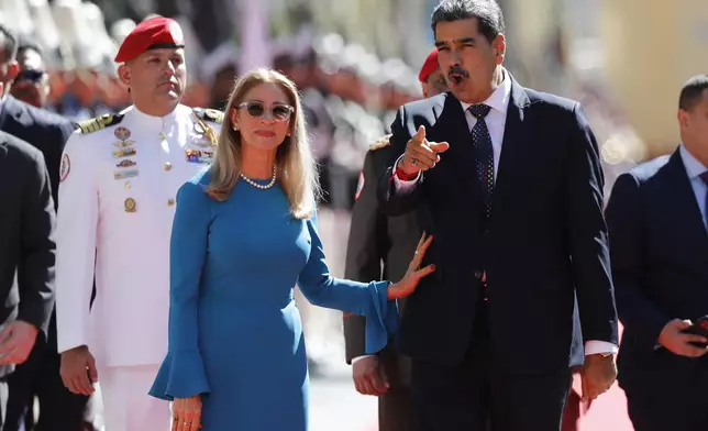 Venezuelan President Nicolas Maduro and his wife Cilia Flores arrive at the National Assembly for his swearing-in ceremony for a third term in Caracas, Venezuela, Friday, Jan. 10, 2025. (AP Photo/Cristian Hernandez)