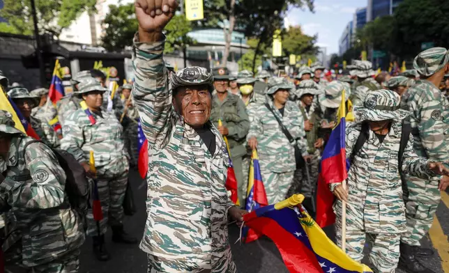 Government-backed militias march in Caracas, Venezuela, Thursday, Jan. 9, 2025, the day before President Nicolas Maduro's inauguration for a third term. (AP Photo/Cristian Hernandez)