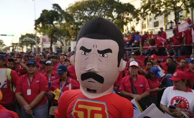 A pro-government supporter dressed as Super Mustache, a character depicting President Nicolas Maduro as a superhero, partakes in a rally at Miraflores Palace, days ahead of Maduro's presidential inauguration for a third term in Caracas, Venezuela, Wednesday, Jan 8, 2025. (AP Photo/Ariana Cubillos)