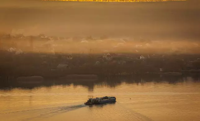 A ferry sails to the left bank of the Dniester river, the border between Moldova and Transnistria, seen from Molovata, Moldova, Wednesday, Jan. 8, 2025. (AP Photo)