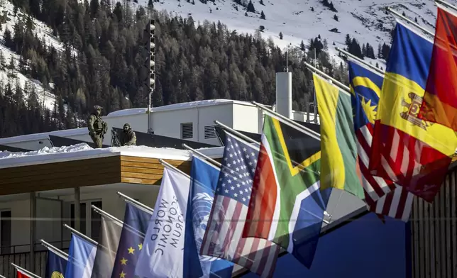 Special police is on guard on the roof of the congress hotel prior to the 55th annual meeting of the World Economic Forum, WEF, in Davos, Switzerland, Monday, Jan. 20, 2025. (Michael Buholzer/Keystone via AP)